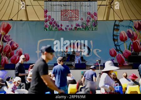 (190914) -- CANBERRA, Sept. 14, 2019 -- People attend a concert during Floriade, an annual flower and entertainment festival, at the Commonwealth Park in Canberra, Australia, Sept. 14, 2019. The festival opens from Sept. 14 to Oct. 13 in Canberra. (Photo by /Xinhua) AUSTRALIA-CANBERRA-FLORIADE ChuxChen PUBLICATIONxNOTxINxCHN Stock Photo