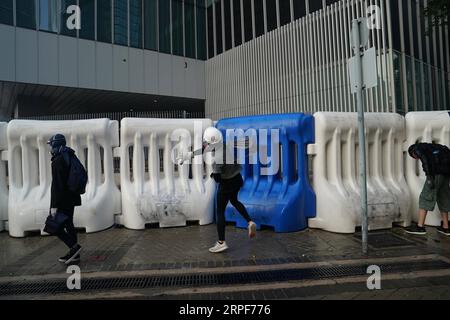 (190915) -- HONG KONG, Sept. 15, 2019 -- A rioter damages public ...