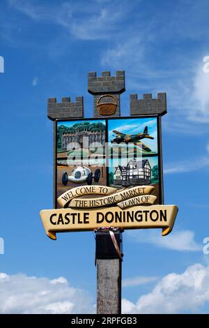 Village sign of Castle Donington showing its history with racing track, aircraft production in WW2, and stately houses. Stock Photo