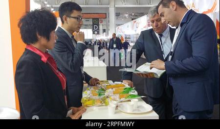 190927 -- CHANGCHUN, Sept. 27, 2019 -- File photo taken on Oct. 21, 2014 shows Sui Shuxia 1st L talks with clients at a food fair in Paris, France. Sui, 52, started her corn business seven years ago. With support from local government, corn products of Sui s company promote well in oversea market. So far the annual corn production of 16 planting bases in northeast China reached 25,000 tonnes. The total output value is expected to exceed 150 million yuan about 21.04 million U.S. dollars this year. In the future, Sui plans to improve the deep processing of corns and expand offline market.  CHINA Stock Photo