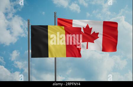 Canada and Belgium flag waving together in the wind on blue sky, two country cooperation concept Stock Photo