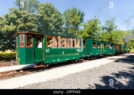 Nagycenki Szechenyi Muzeumvasut narrow gauge railway. Passenger train pulled by 'Andras' steam locomotive leaving Kastely station, Nagycenk, Hungary Stock Photo