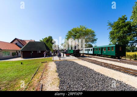 Nagycenki Szechenyi Muzeumvasut narrow gauge railway. Passenger train pulled by 'Andras' steam locomotive at Kastely station, Nagycenk, Hungary Stock Photo