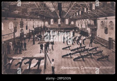 Soldiers performing gymnastic excercises at a military gymnasium in Aldershot England, process print c1900 Stock Photo