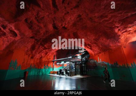 191010 -- STOCKHOLM, Oct. 10, 2019 -- Passengers walk in the Solna Centrum metro station in Stockholm, Sweden, Oct. 8, 2019. Till now, Stockholm s subway system consists of one hundred stations, each with unique art on its platform, walls or waiting hall. Since 1957, artists have been greatly involved in the building of new stations, and they also added beautiful statues, murals, and installations to the older stations.  SWEDEN-STOCKHOLM-TRANSPORTATION-METRO-ART ZhengxHuansong PUBLICATIONxNOTxINxCHN Stock Photo