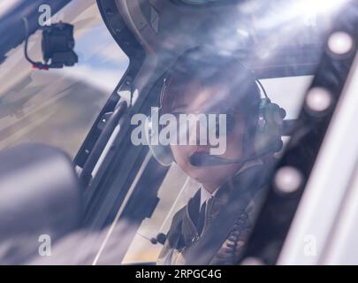 191011 -- LHASA, Oct. 11, 2019 -- Jianre Yixi prepares to fly a helicopter in southwest China s Tibet Autonomous Region, Aug. 7, 2019. The Qinghai-Tibet Plateau was once known as a no-fly zone and it was extremely difficult to fly helicopters there. Now, after professional and intensive training, the first batch of young Tibetans has flown civilian helicopters to the Mt. Qomolangma base camp. Jianre Yixi is from an impoverished herdsman family in Damxung County, Tibet. In 2016, Jianre Yixi, a student at Lhasa s No. 2 Secondary Vocational and Technical School, received a call to change her fate Stock Photo