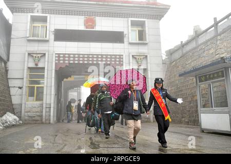 191011 -- LHASA, Oct. 11, 2019 -- A Chinese border control officer 1st R leads a group of Indian pilgrims as they enter China from Nathu La Pass in Yadong County, southwest China s Tibet Autonomous Region, June 20, 2019. TO GO WITH China Focus: Pilgrimage boosts exchanges between China, India  CHINA-TIBET-INDIA-PILGRIMAGE-EXCHANGE CN LixXin PUBLICATIONxNOTxINxCHN Stock Photo