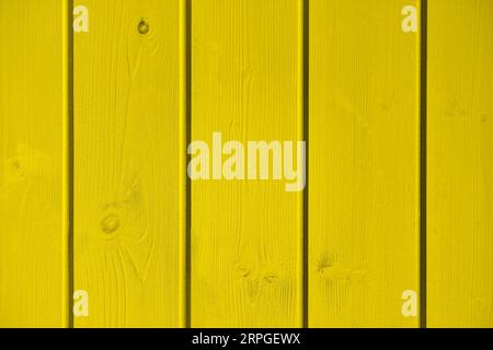 Wooden planks background painted in yellow color. Wooden texture. Well use for display product and text on copy space. Stock Photo
