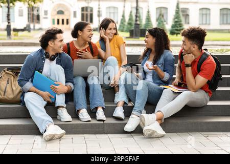 Group Of Multiethnic Students Chatting And Having Fun After Classes Stock Photo