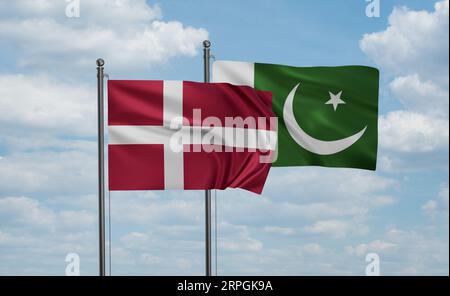 Pakistan flag and Denmark flag waving together on blue sky, two country cooperation concept Stock Photo