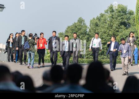 191020 -- TONGXIANG, Oct. 20, 2019 -- Attendants enter the conference hall of the opening ceremony of the sixth World Internet Conference held in Wuzhen, east China s Zhejiang Province, Oct. 20, 2019.  CHINA-ZHEJIANG-WUZHEN-WORLD INTERNET CONFERENCE-OPENINGCN ZhangxXiaoyu PUBLICATIONxNOTxINxCHN Stock Photo
