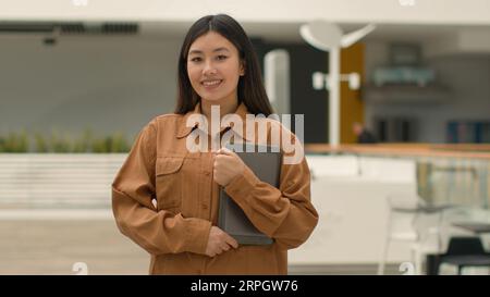 Asian chinese ethnic korean businesswoman employer in office company posing with digital tablet. Portrait happy Japanese woman corporate staff hr Stock Photo