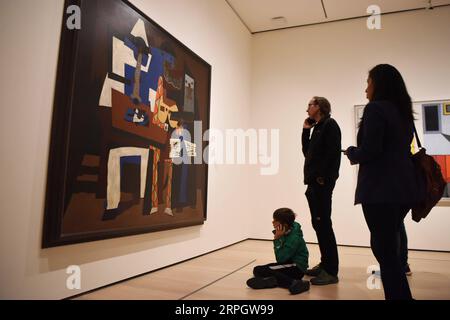 191023 -- NEW YORK, Oct. 23, 2019 -- Visitors view the painting Three Musicians by Spanish artist Pablo Picasso in the Museum of Modern Art MoMA in Manhattan of New York, the United States, Oct. 22, 2019. MoMA was reopened to the public on Monday after being closed since June 15 for renovation and reorganization of its galleries.  U.S.-NEW YORK-MOMA-REOPENING HanxFang PUBLICATIONxNOTxINxCHN Stock Photo