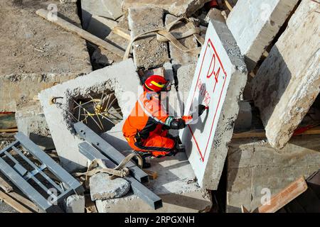 191024 -- BEIJING, Oct. 24, 2019 -- A member of China Search and Rescue Team makes a mark during an earthquake search and rescue training at a training base in Daxing District of Beijing, capital of China, Oct. 21, 2019. China Search and Rescue Team and China International Search and Rescue Team successfully passed UN assessments respectively on Wednesday, making China the first Asian country owning two heavy Urban Search and Rescue USAR teams certified by the United Nations.  CHINA-BEIJING-USAR TEAMS-OBTAINING UN CERTIFICATION CN ShenxBohan PUBLICATIONxNOTxINxCHN Stock Photo