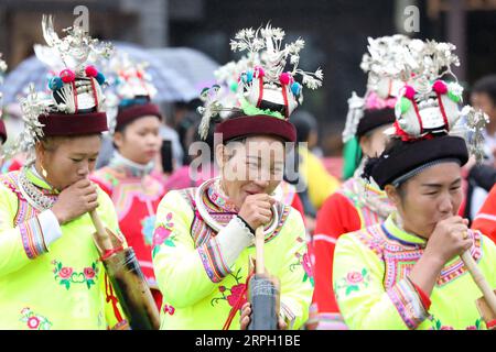 191026 -- DANZHAI, Oct. 26, 2019 -- Women of the Miao ethnic group perform a dance with Lusheng, a folk musical instrument made of bamboo pipes, during celebration of the Chixin festival in Danzhai County, Qiandongnan Miao and Dong Autonomous Prefecture, southwest China s Guizhou Province, Oct. 26, 2019. Local residents of the Miao ethnic group were joined by tourists on Saturday in celebrating their traditional Chixin festival for this year s harvest.  CHINA-GUIZHOU-DANZHAI-CHIXIN FESTIVAL-CELEBRATION CN OuxDongqu PUBLICATIONxNOTxINxCHN Stock Photo