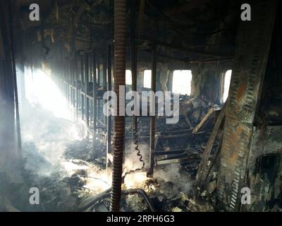 191031 -- RAHIM YAR KHAN, Oct. 31, 2019 -- Photo taken with mobile phone shows a burnt compartment of a passenger train in Rahim Yar Khan district of Pakistan s east Punjab province on Oct. 31, 2019. At least 65 people were killed and 14 others injured after a passenger train caught fire in Rahim Yar Khan district of Pakistan s east Punjab province on Thursday, a rescue official and local reports said. The death toll is feared to rise as rescue work continues to recover more bodies from the compartments gutted in the fire, Baqir Hussain, district emergency officer of state-owned Rescue 1122, t Stock Photo