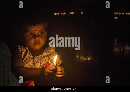 191101 -- BEIJING, Nov. 1, 2019 -- A child lights candles at a village some 160 km away from Kolkata, India, on Oct. 27, 2019. Photo by /Xinhua Portraits of Oct. 2019 TumpaxMondal PUBLICATIONxNOTxINxCHN Stock Photo