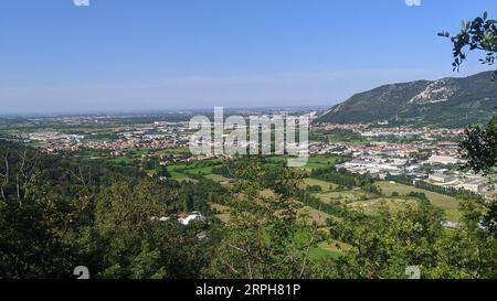ountains in clouds at sunrise in summer. Aerial view of mountain peak with green trees Stock Photo