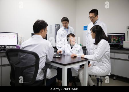 191103 -- SHANGHAI, Nov. 3, 2019 -- Geng Meiyu C, key inventor of the drug GV-971, also a researcher of Shanghai Institute of Materia Medica under Chinese Academy of Sciences, discusses the research progress with her team at the Green Valley institute in Shanghai, east China, Nov. 3, 2019. A home-grown drug for treating Alzheimer s disease has been approved by the National Medical Products Administration to hit the market, according to its developers Saturday. The drug, GV-971, was developed by Ocean University of China, Shanghai Institute of Materia Medica under Chinese Academy of Sciences an Stock Photo