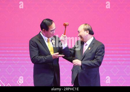 191104 -- BANGKOK, Nov. 4, 2019 -- Thai Prime Minister Prayut Chan-o-cha L hands over the chairmanship of the Association of Southeast Asian Nations ASEAN to Vietnamese Prime Minister Nguyen Xuan Phuc at the closing ceremony of the 35th ASEAN Summit and the related summits in Bangkok, Thailand, Nov. 4, 2019. Rachen Sageamsak THAILAND-BANGKOK-ASEAN SUMMIT-RELATED SUMMITS-CONCLUSION ZhangxKeren PUBLICATIONxNOTxINxCHN Stock Photo