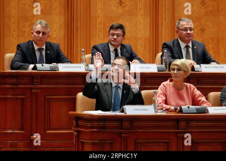 191104 -- BUCHAREST, Nov. 4, 2019 Xinhua -- Ludovic Orban L, Front, leader of the Romanian National Liberal Party, gestures during a parliament session in Bucharest, capital of Romania, on Nov. 4, 2019. The Romanian National Liberal government won a vote of confidence in parliament on Monday, replacing the Social Democrats who had been in power for nearly three years. Photo by Cristian Cristel/Xinhua ROMANIA-BUCHAREST-NATIONAL LIBERAL GOVERNMENT-VOTE OF CONFIDENCE PUBLICATIONxNOTxINxCHN Stock Photo