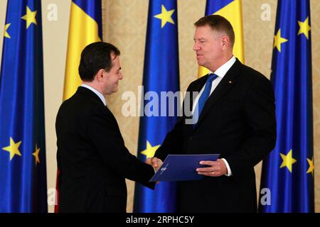 191104 -- BUCHAREST, Nov. 4, 2019 Xinhua -- Romanian President Klaus Iohannis R shakes hands with new Prime Minister Ludovic Orban during the swearing-in ceremony in Bucharest, Romania, on Nov. 4, 2019. Romania s new cabinet headed by National Liberal leader Ludovic Orban took the oath of office late Monday before President Klaus Iohannis at the Cotroceni Presidential Palace. Photo by Cristian Cristel/Xinhua ROMANIA-BUCHAREST-NEW GOVERNMENT-SWEARING-IN PUBLICATIONxNOTxINxCHN Stock Photo