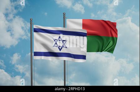 Madagascar and Israel flags waving together on blue cloudy sky, two ...