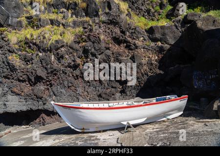 An traditional wooden whaling boat now used for racing onshore at Porto do Nordeste, a tiny fishing village in Nordeste, Sao Miguel Island, Azores, Portugal. Stock Photo