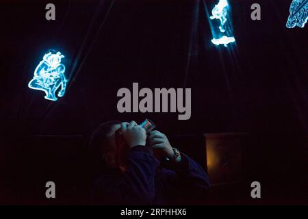 191109 -- BEIJING, Nov. 9, 2019 -- Liu Gaochao takes photos of an exhibition at the 798 art zone in Beijing, capital of China, Nov. 9, 2019. It s been more than five years since Liu Gaochao embraced a career in film developing. On top of a high-rise mansion next to Liufang Station of Beijing Subway Line 13, Liu runs a studio, New Wave Film Lab, which also provides him a place to live. In 2012, Liu left his hometown in central China s Henan Province and headed for Beijing in pursuit of better opportunities. After he settled down in the capital city, he came across film photography and fell for Stock Photo