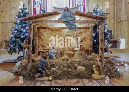 Christmas Manger scene with figurines including Jesus, Mary, Joseph, sheep and magi Stock Photo