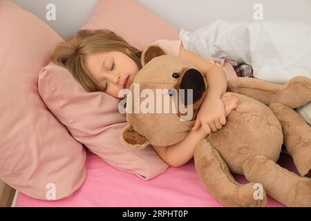 Little girl snoring while sleeping in bed Stock Photo