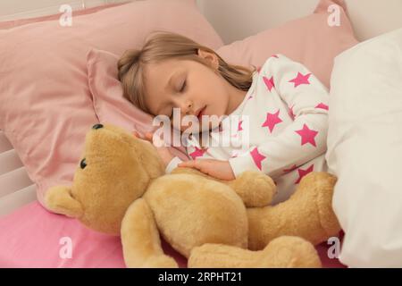 Little girl snoring while sleeping in bed Stock Photo