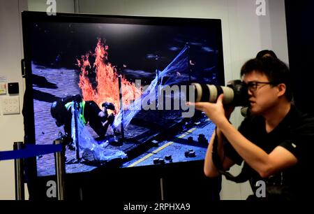 191119 -- HONG KONG, Nov. 19, 2019 -- An evidence image of violent acts by rioters is shown at a press conference in Hong Kong, south China, Nov. 18, 2019. Hong Kong police on Monday condemned the escalating violence of rioters, saying their latest attacks imitated terrorism, after a car attempted to hit an officer and a large group of rioters took away an arrested woman by force. CHINA-HONG KONG-POLICE-PRESS CONFERENCE CN ZhuxXiang PUBLICATIONxNOTxINxCHN Stock Photo