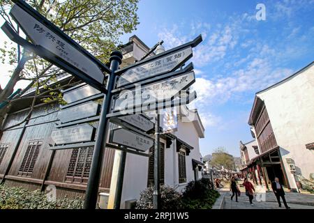 191123 -- HANGZHOU, Nov. 23, 2019 -- Photo taken on Nov. 23, 2019 shows the renovated Pingyao old street in Pingyao Town of Yuhang District in Hangzhou, east China s Zhejiang Province. Pingyao old street was officially opened after two years of comprehensive renovation. The renovated street fully retains the style of the 1970s and 1980s. After the transformation of the old street, it has also introduced a variety of commercial formats such as traditional cakes, tea, Chinese food, western food, cultural innovation and non-staple food retail, turning into a cultural block with beautiful environm Stock Photo