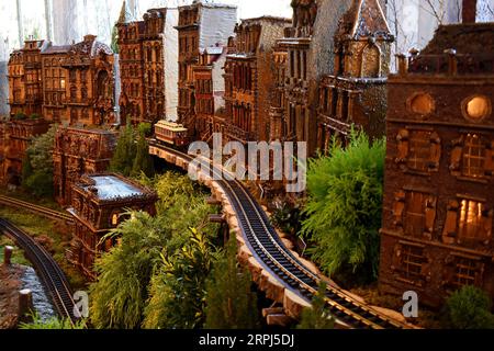 191127 -- NEW YORK, Nov. 27, 2019 -- A model train runs through the miniature buildings at the Holiday Train Show at New York Botanical Garden in New York, the United States, Nov. 26, 2019. The New York Botanical Garden is rolling into the holiday season with its annual holiday train show. Now in its 28th edition, the annual event transports visitors to a miniature metropolis as model trains zip through an enchanting display of more than 175 landmarks in New York City, each recreated with bark, lotus pods, acorns, cinnamon sticks and other natural materials. This year s show lasts from Nov. 23 Stock Photo