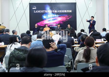 191128 -- BEIJING, Nov. 28, 2019 Xinhua -- Liu Jifeng 1st R Back, deputy director-general of the National Astronomical Observatory of the Chinese Academy of Sciences NAOC and the first author of the study, speaks during a press conference of the black hole LB-1 discovered with the Large Sky Area Multi-Object Fibre Spectroscopy Telescope LAMOST, in Beijing, capital of China, Nov. 27, 2019. A Chinese-led research team has discovered a surprisingly huge stellar black hole about 14,000 light years from Earth -- our backyard of the universe -- forcing scientists to re-examine how such black holes f Stock Photo