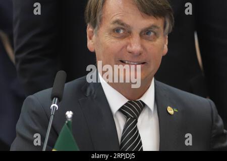 191206 -- BENTO GONCALVES, Dec. 6, 2019 -- Brazilian President Jair Messias Bolsonaro attends the 55th summit of the South American trade bloc Mercosur Southern Common Market in Bento Goncalves, Brazil, Dec. 5, 2019. The 55th summit of Mercosur, which gathers South American countries Brazil, Argentina, Paraguay and Uruguay, opened on Thursday in the southern Brazilian city of Bento Goncalves. As the host of the summit, Brazil s President Jair Bolsonaro highlighted the bloc s revival this year, thanks to trade agreements reached with the European Union EU and the European Free Trade Association Stock Photo