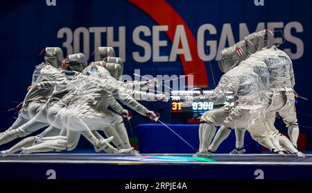 191207 -- BEIJING, Dec. 7, 2019 -- Nguyen Xuan Loi R of Vietnam competes with Soravit Kitsiriboon of Thailand during the men s team sabre fencing final match between Vietnam and Thailand at the Southeast Asian Games 2019 in Pasay City, the Philippines, Dec. 6, 2019.  XINHUA PHOTOS OF THE DAY ROUELLExUMALI PUBLICATIONxNOTxINxCHN Stock Photo