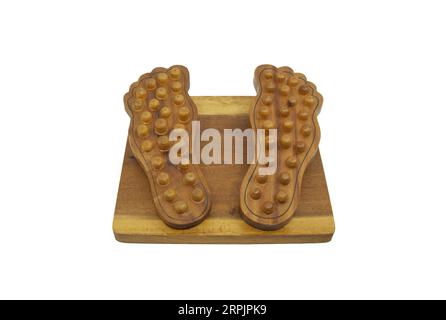 Isolated wooden foot massage on white background, perspective view from heel part,  traditional wooden foot tool massage in the shape of the foot. Stock Photo