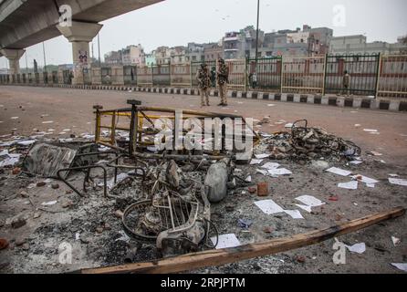 191217 -- NEW DELHI, Dec. 17, 2019 -- Indian policemen stand near the wreckage of motorcycles which were set on fire during protests in New Delhi, India, Dec. 17, 2019. Fresh violence was reported from parts of Delhi on Tuesday against the new Citizenship Amendment Act CAA, which was passed by the country s Parliament last week, TV media reports said.  INDIA-NEW DELHI-PROTESTS-NEW CITIZENSHIP ACT JavedxDar PUBLICATIONxNOTxINxCHN Stock Photo