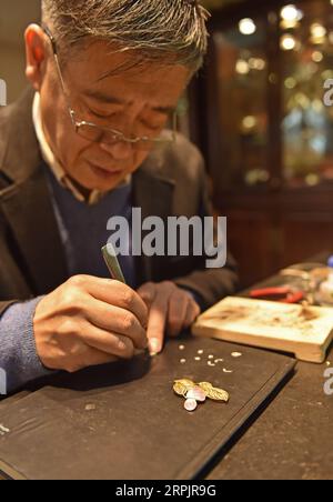 191218 -- BEIJING, Dec. 18, 2019 -- Dong Ruijing engraves Chinese ...