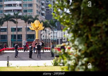 191218 -- MACAO, Dec. 18, 2019 -- People pose for photos at the Golden Lotus Square in Macao, south China, Dec. 18, 2019. Over the past two decades, the special administrative region has made great strides in economic development and achieved prosperity and stability under the one country, two systems principle.  CHINA-MACAO-DAILY LIFE CN LixJing PUBLICATIONxNOTxINxCHN Stock Photo