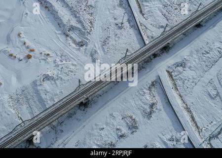 191218 -- GOLMUD, Dec. 18, 2019 -- Aerial photo taken on Dec. 16, 2019 shows the view of a railway bridge near the Da Qaidam Station along the Dunhuang-Golmud railway in northwest China s Qinghai Province. A new railway linking Dunhuang city, northwest China s Gansu Province, and Golmud city, northwest China s Qinghai Province, fully opened on Wednesday, according to China Railway. The 671-km route is an important connecting line between the Qinghai-Tibet Railway and the Lanzhou-Xinjiang Railway. It allows trains to run at 120 km per hour, said the company.  CHINA-QINGHAI-GOLMUD-DUNHUANG-GOLMU Stock Photo