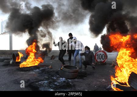 191220 -- TRIPOLI LEBANON, Dec. 20, 2019 Xinhua -- Protesters burn tyres to block the road in Lebanon s northern city Tripoli on Dec. 20, 2019. Protesters in Tripoli blocked roads on Friday to protest against the appointment of Hassan Diab as the new prime minister. Photo by Khalid/Xinhua LEBANON-TRIPOLI-PROTEST PUBLICATIONxNOTxINxCHN Stock Photo