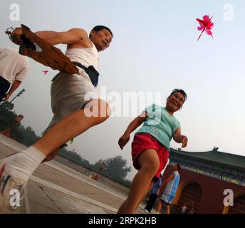 191226 -- BEIJING, Dec. 26, 2019 -- People play shuttlecock kicking at the Tiantan Park in Beijing, capital of China, Aug. 8, 2006. Urban parks in China offer easy place for people to relax and unwind. Furthermore, China s urban parks feature more less-impact exercise equipment and ways to have fun for young and old. With the breeze blowing and boats floating in the parks, people enjoyed dancing, singing and folklore performance from 1950s to 1990s. Nowadays, people have more choices of activities in the parks, like the fashion show by the elderly locals and the low expense wedding ceremony fo Stock Photo