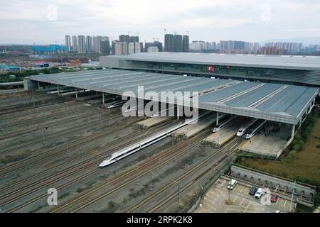 191226 -- NANCHANG, Dec. 26, 2019 -- Aerial photo taken on Dec. 26, 2019 shows the first high-speed train G5025 leaving Nanchang West Station after the opening of Nanchang-Ganzhou high-speed railway in Nanchang, capital of east China s Jiangxi Province. A high-speed railway opened on Thursday threading Nanchang, capital of east China s Jiangxi Province, Jinggangshan, the cradle of the Chinese revolution, and China s rare earth base of Ganzhou. The high-speed railway with a design speed of 350 km per hour shortens the former train trip of more than 4 hours to less than 2 hours on the 418-km lin Stock Photo