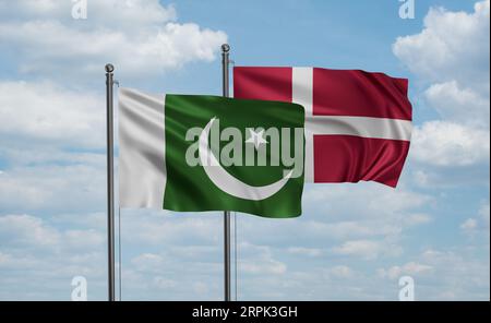 Denmark flag and Pakistan flag waving together on blue sky, two country cooperation concept Stock Photo