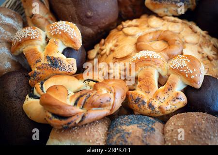 Different kinds of fresh bread as background, bakery food concept Stock Photo