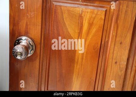 A close up of a wooden door with handle. Stock Photo