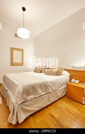 Hotel apartment bedroom. Minimalism interior design. Contemporary decoration. Indoor Stock Photo